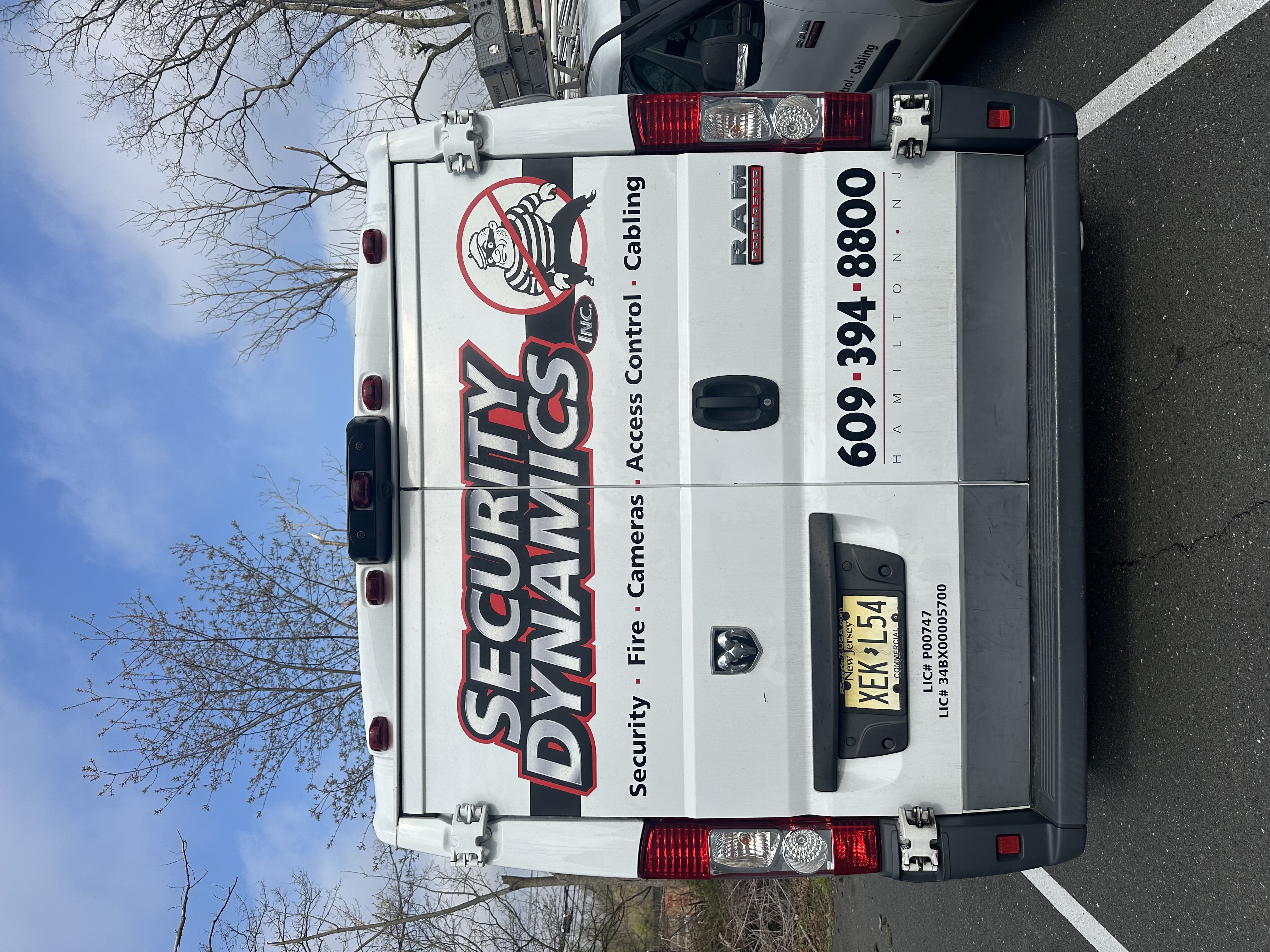 Security Dynamics service van — rear view showing Security, Fire, Cameras, Access Control, Cabling services